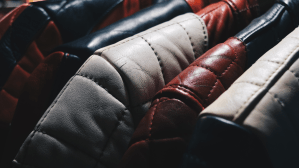 up close photo of a rack of leather jackets in various colors
